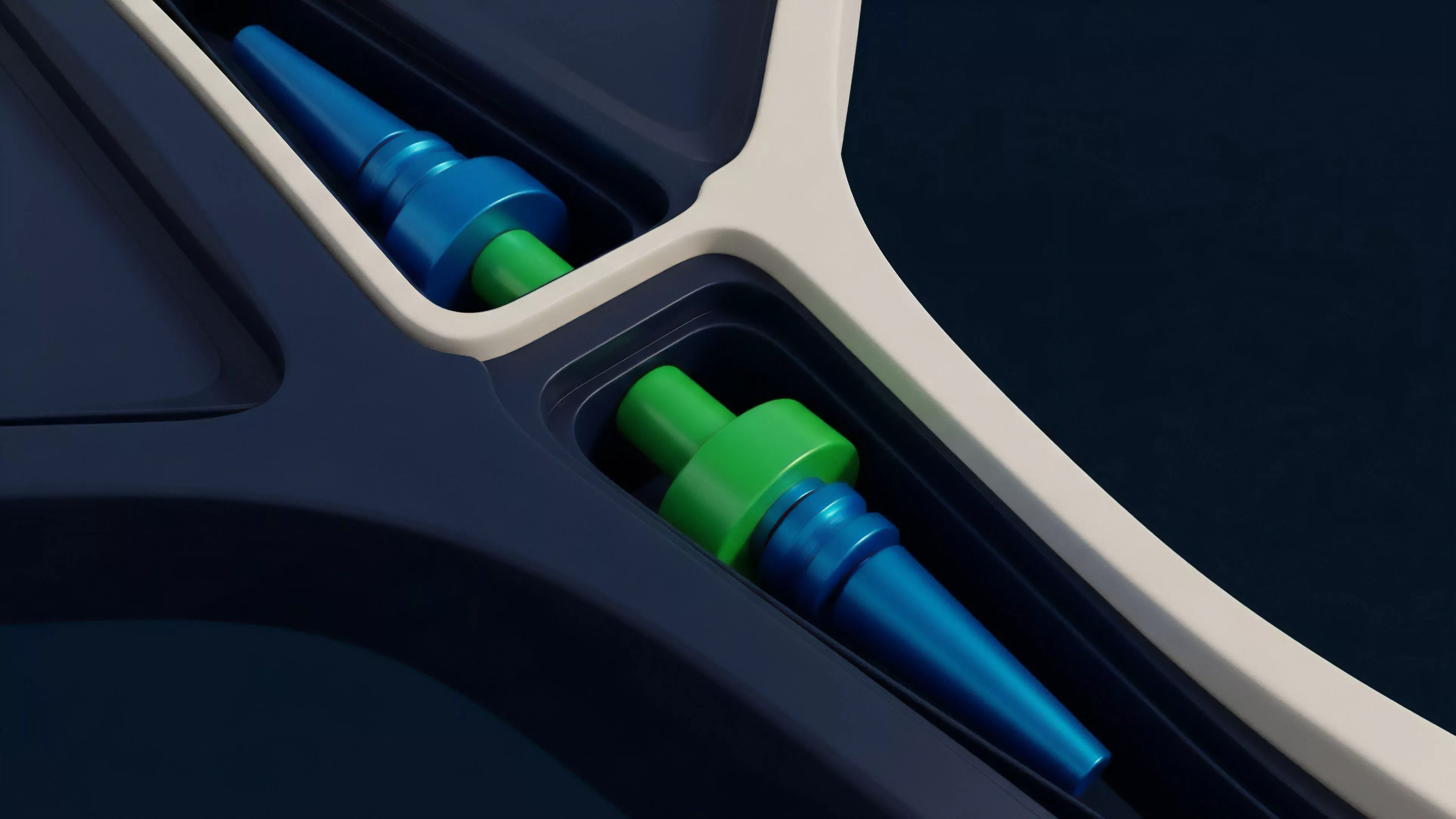 The image displays two symmetrical high-gloss components ⎊ one predominantly blue and green the other green and blue ⎊ set within recessed slots of a dark blue contoured surface. A light-colored trim traces the perimeter of the component recesses emphasizing their precise placement in the infrastructure