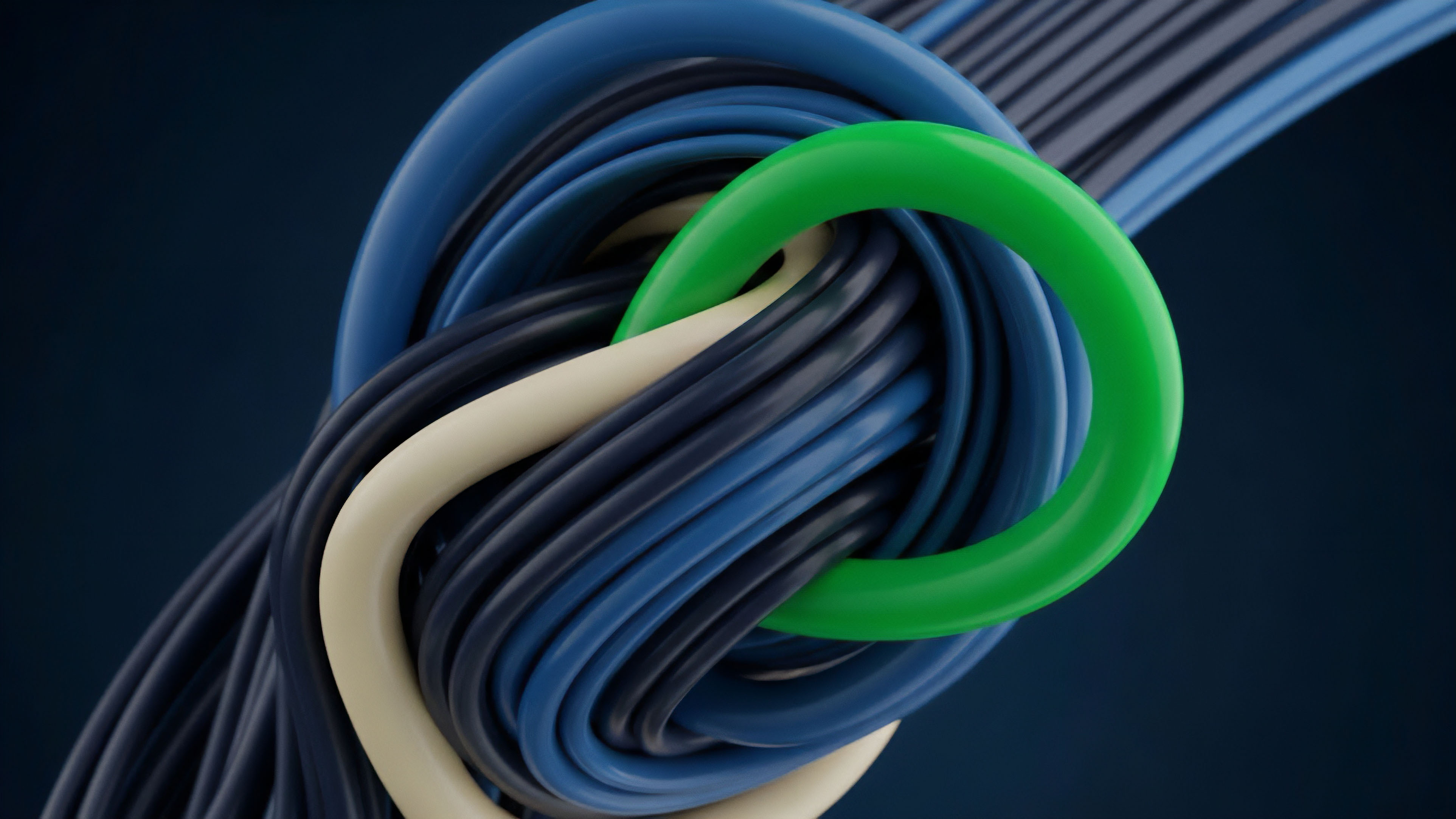 A close-up view captures a bundle of intertwined blue and dark blue strands forming a complex knot. A thick light cream strand weaves through the center, while a prominent, vibrant green ring encircles a portion of the structure, setting it apart