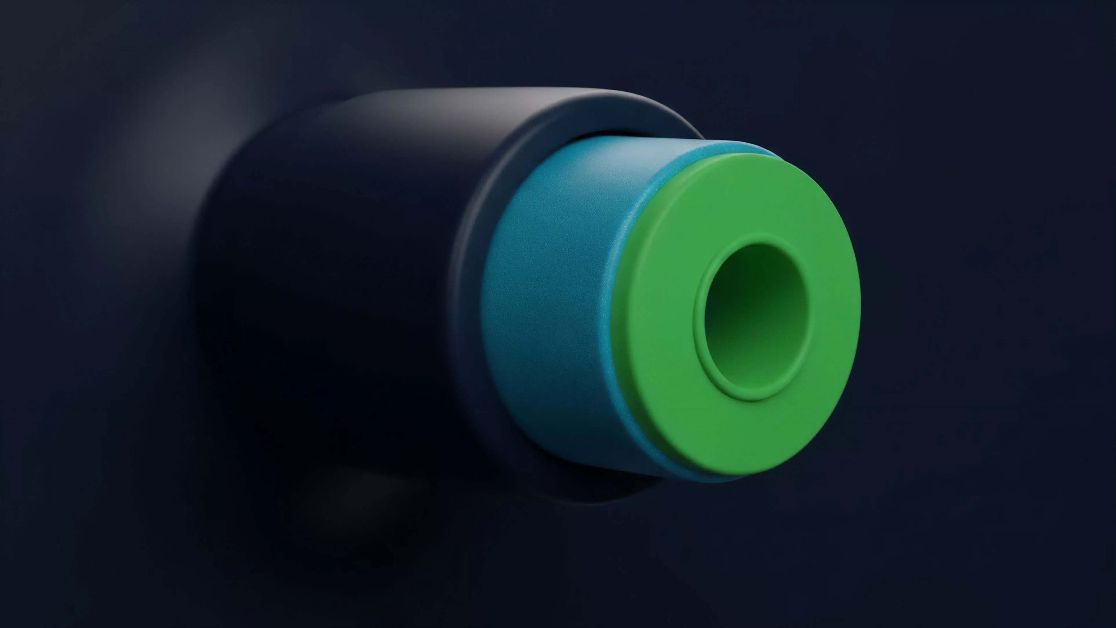 A macro photograph displays a close-up perspective of a multi-part cylindrical object, featuring concentric layers of dark blue, light blue, and bright green materials. The structure highlights a central, circular aperture within the innermost green core