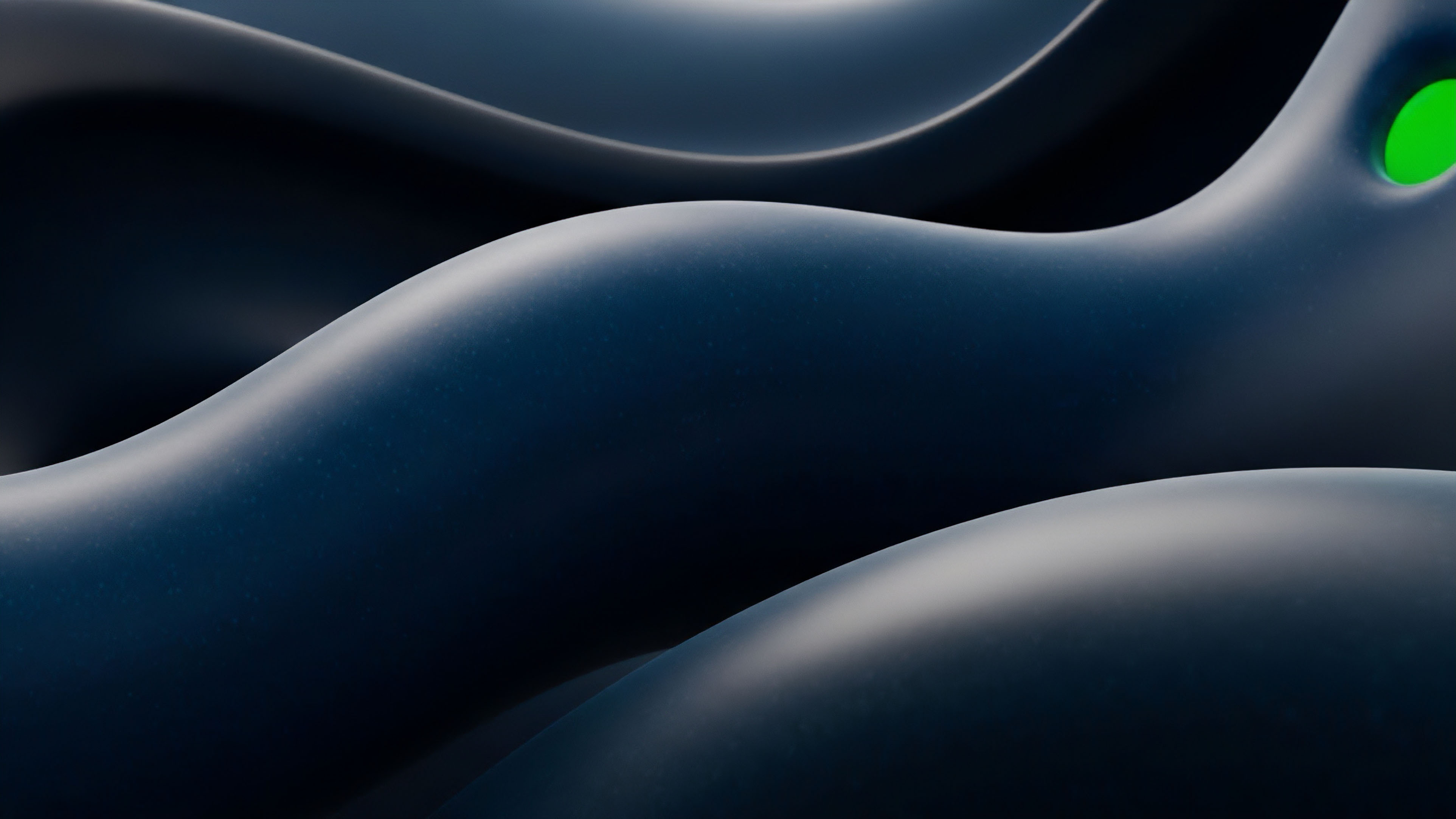 This abstract composition features smooth, flowing surfaces in varying shades of dark blue and deep shadow. The gentle curves create a sense of continuous movement and depth, highlighted by soft lighting, with a single bright green element visible in a crevice on the upper right side