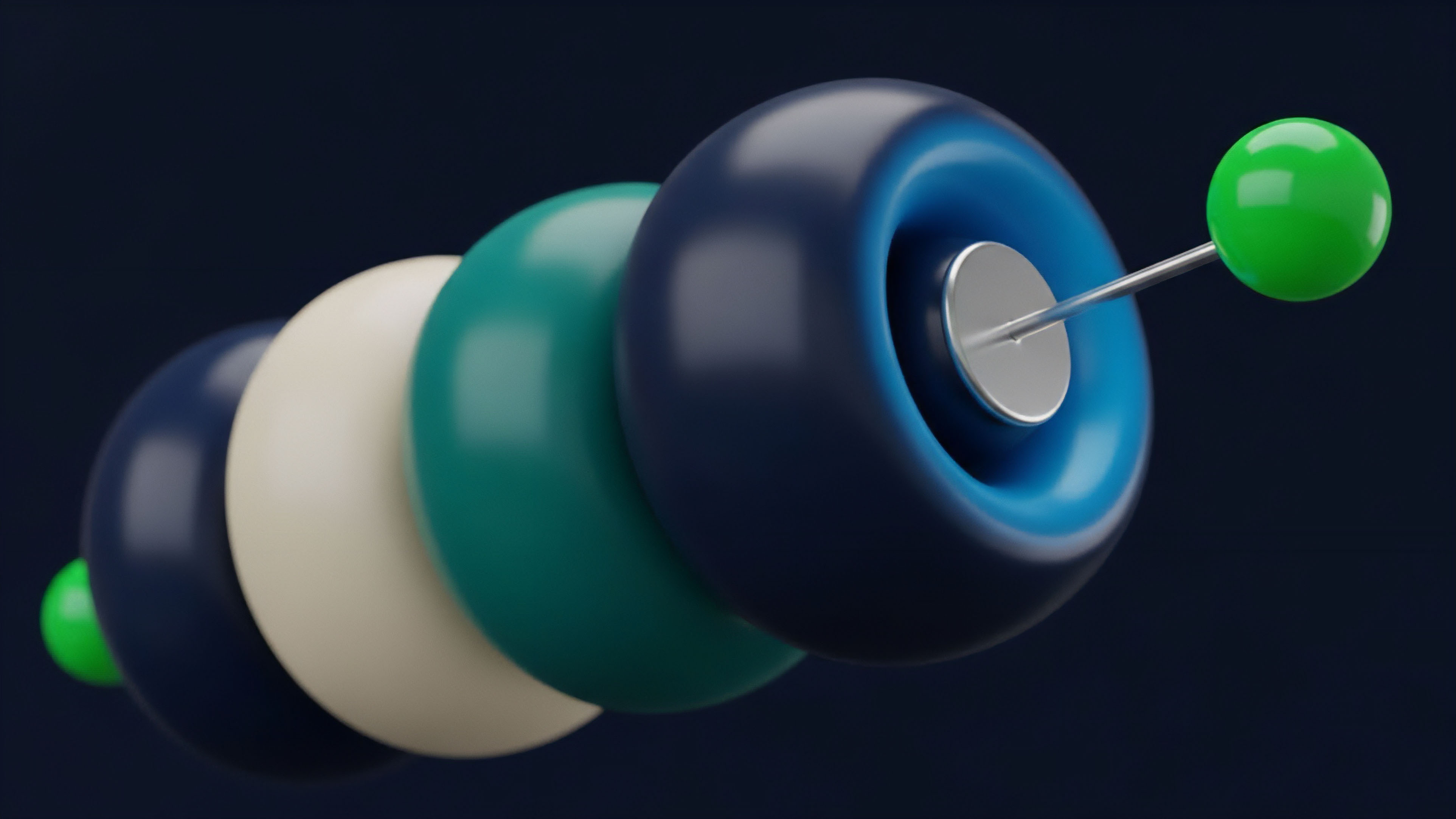 A series of colorful, smooth objects resembling beads or wheels are threaded onto a central metallic rod against a dark background. The objects vary in color, including dark blue, cream, and teal, with a bright green sphere marking the end of the chain